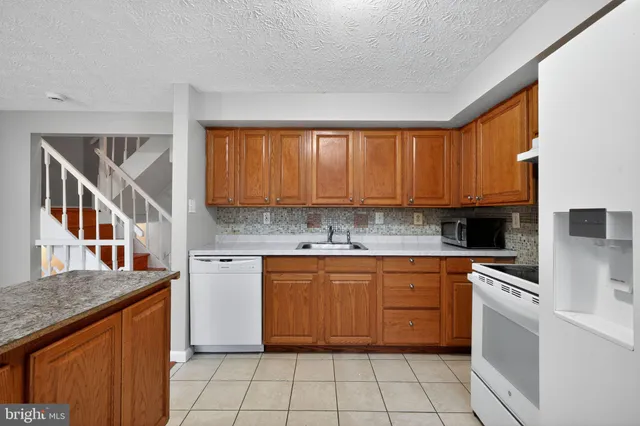 a kitchen with a stove top oven sink and cabinets