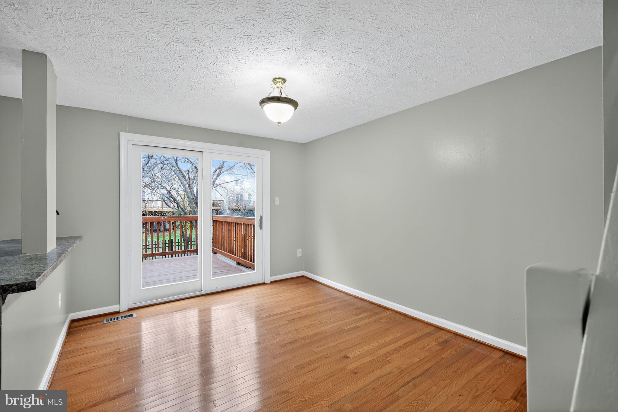 3602 Castle Terrace, Unit 116102 Silver Spring, MD 20904 - Photo 9 of 30 a view of empty room with wooden floor and fan