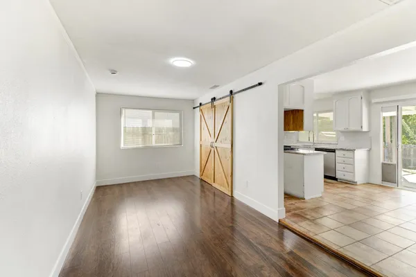 a view of an empty room with wooden floor