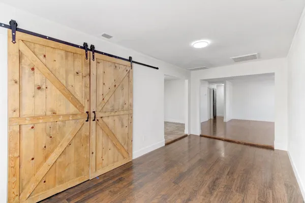 a kitchen with granite countertop a refrigerator and a sink