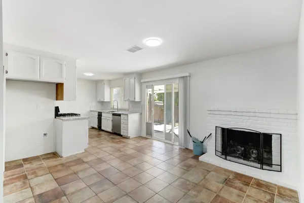 a kitchen with stainless steel appliances granite countertop a stove a sink and white cabinets