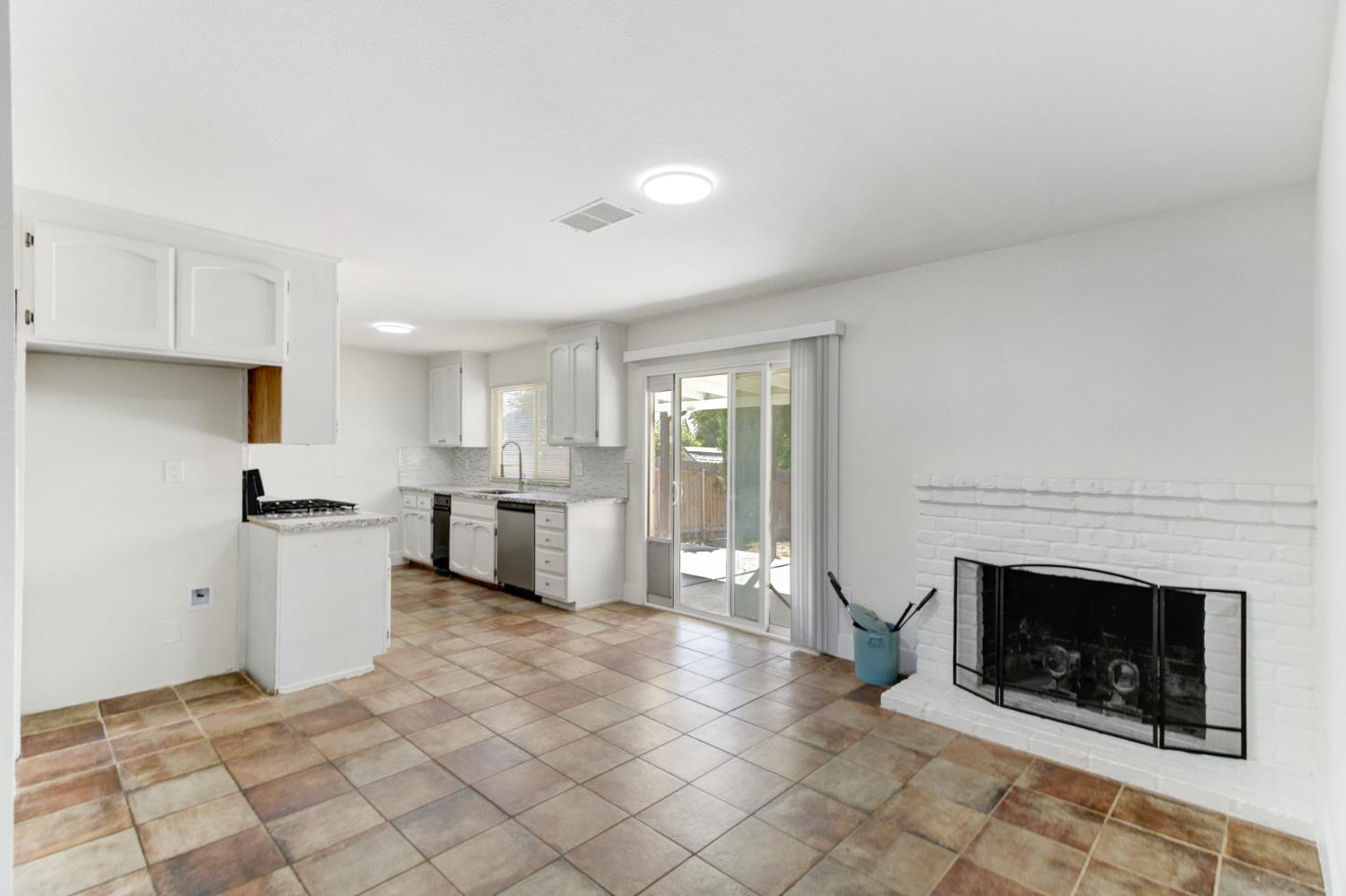 124 Fargo Way Folsom, CA 95630 - Photo 14 of 60 a kitchen with a stove a sink and a fireplace