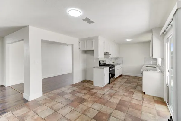 a kitchen with stainless steel appliances a white stove top oven and a refrigerator