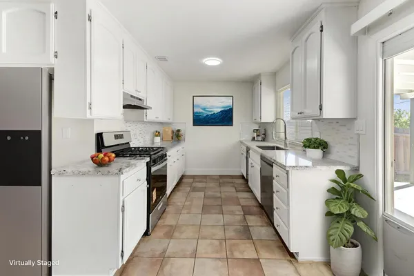 a kitchen with a sink stove and cabinets