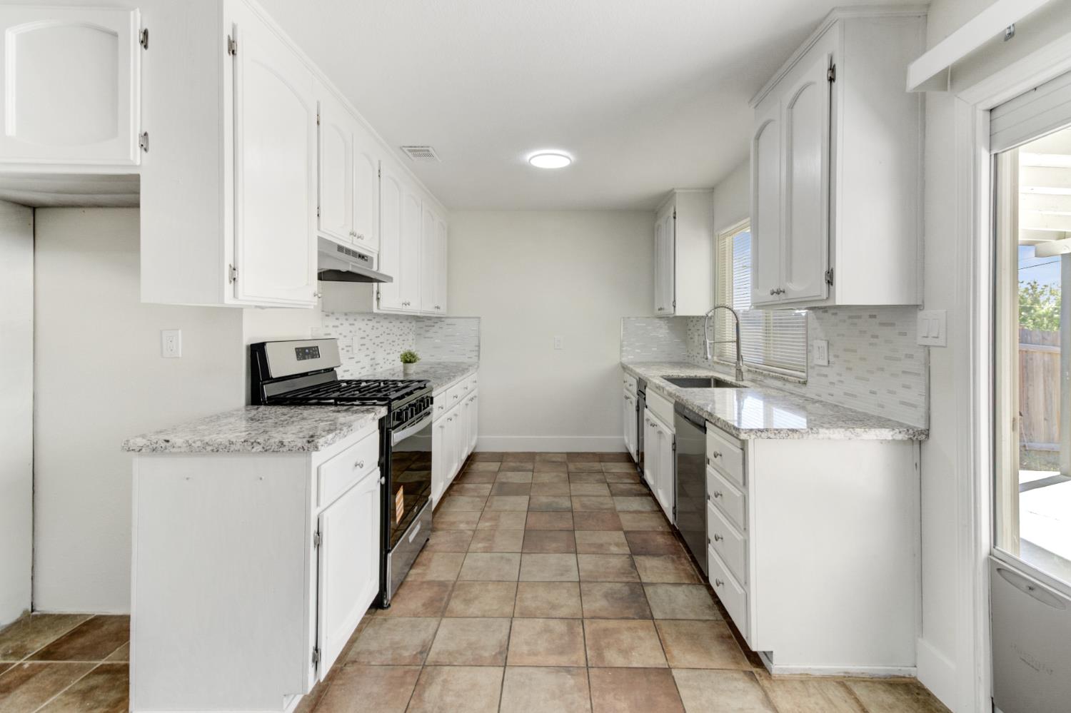 124 Fargo Way Folsom, CA 95630 - Photo 18 of 60 a kitchen with a sink a stove top oven and white stainless steel appliances