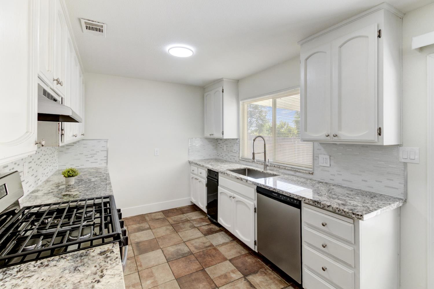 124 Fargo Way Folsom, CA 95630 - Photo 20 of 60 a kitchen with stainless steel appliances granite countertop a stove a sink and a microwave