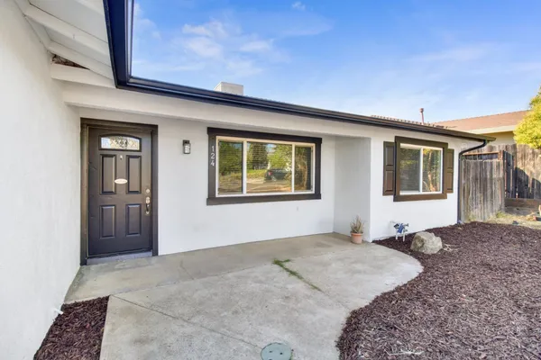 a living room with furniture a rug and a flat screen tv