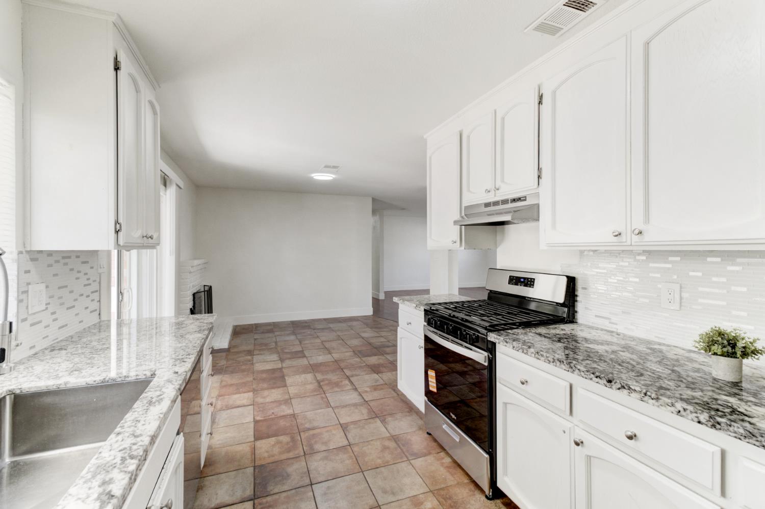124 Fargo Way Folsom, CA 95630 - Photo 21 of 60 a kitchen with granite countertop a stove a sink and a granite counter tops