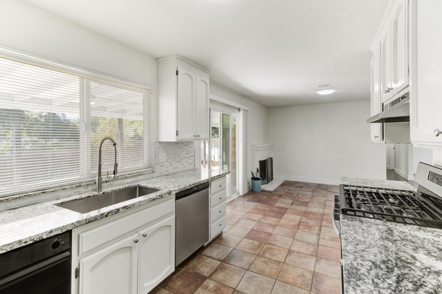 124 Fargo Way Folsom, CA 95630 - Photo 22 of 60 a kitchen with granite countertop a sink a stove and cabinets