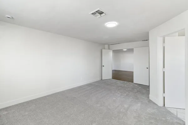a bathroom with a double vanity sink a mirror and a shower