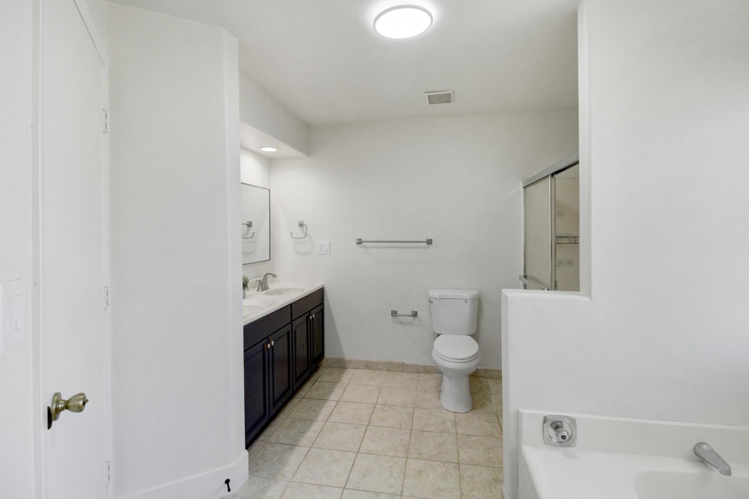 124 Fargo Way Folsom, CA 95630 - Photo 32 of 60 a bathroom with a granite countertop toilet and a sink