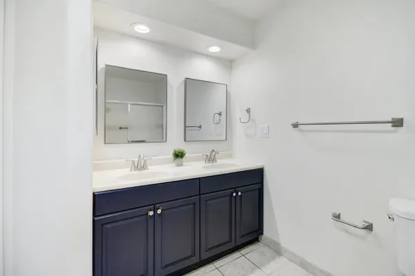 a bedroom with a bed and a tv on the dresser