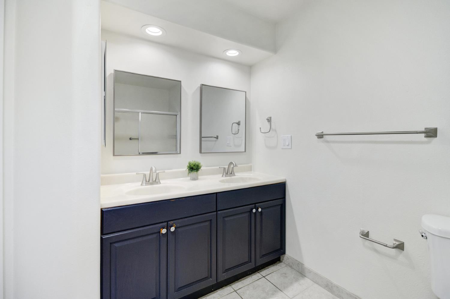 124 Fargo Way Folsom, CA 95630 - Photo 33 of 60 a bathroom with a double vanity sink a mirror and a shower
