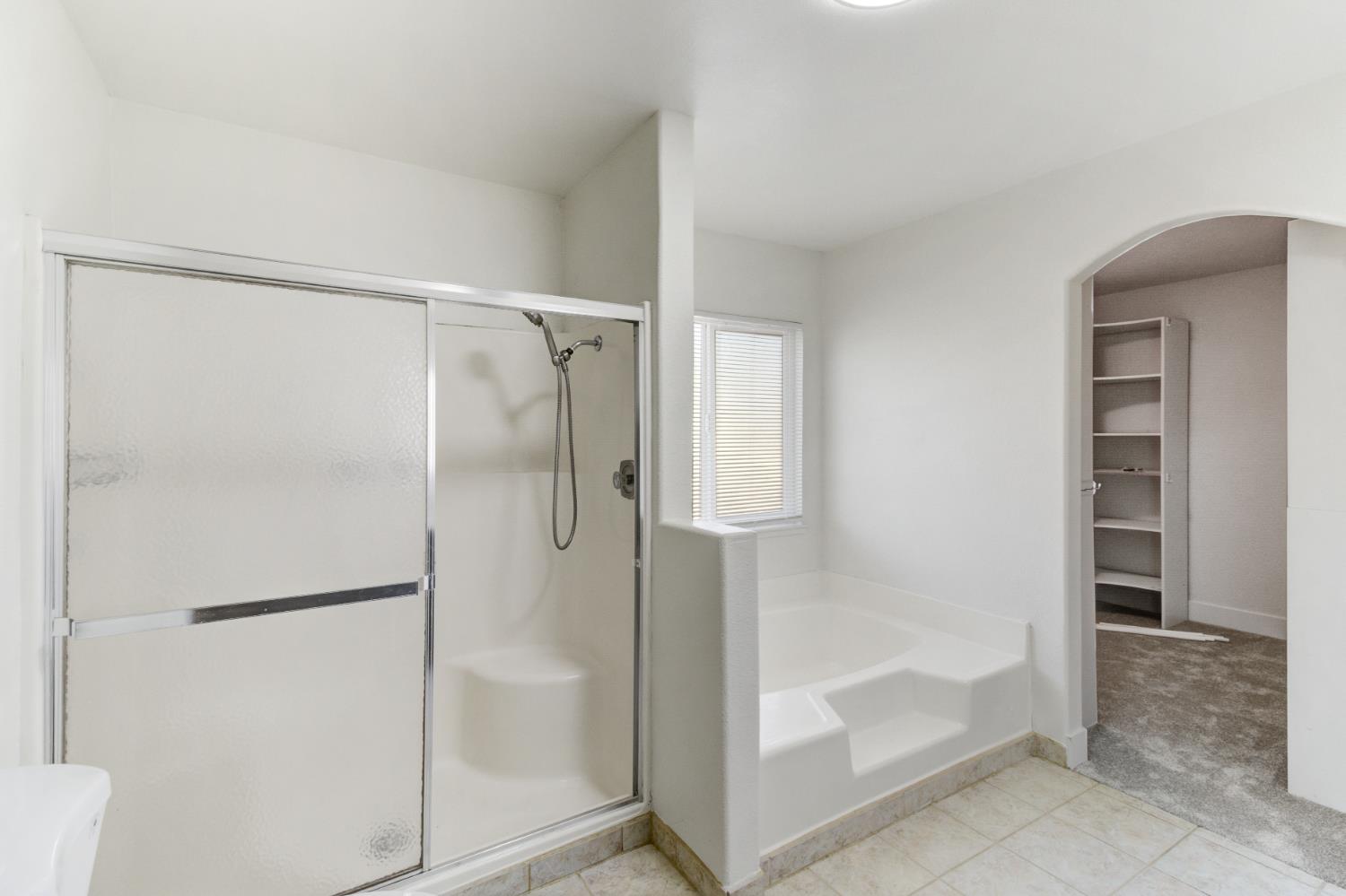 124 Fargo Way Folsom, CA 95630 - Photo 34 of 60 a bathroom with a glass shower door