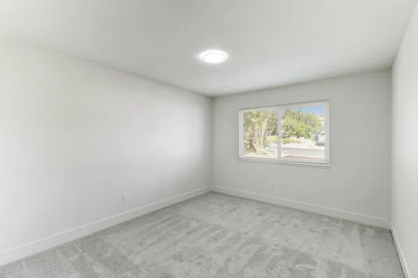 a bathroom with a granite countertop bathtub sink vanity mirror and toilet