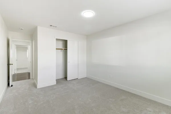 a bathroom with a bathtub shower sink vanity mirror and toilet
