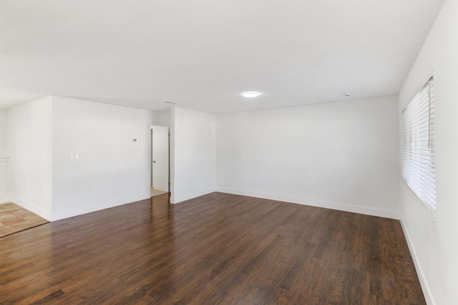 124 Fargo Way Folsom, CA 95630 - Photo 5 of 60 an empty room with wooden floor and windows
