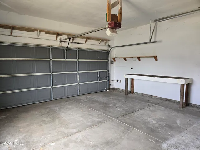 a view of an empty room with cabinet and a window