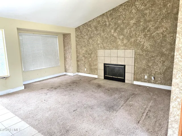 a view of empty room with a fireplace
