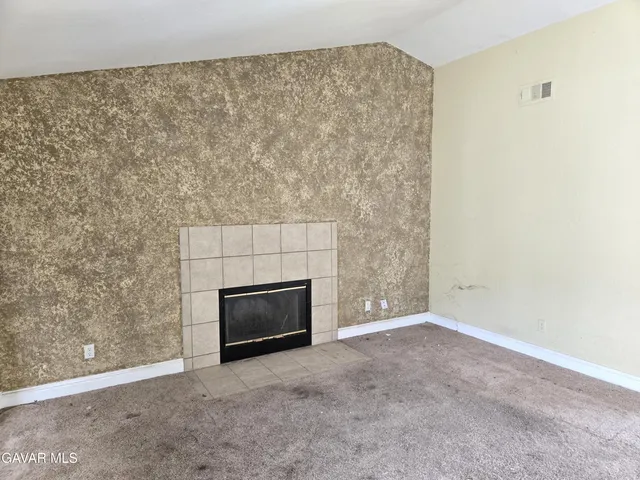 a view of empty room with a fireplace