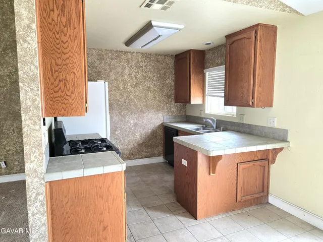 a kitchen with a stove a sink and a microwave