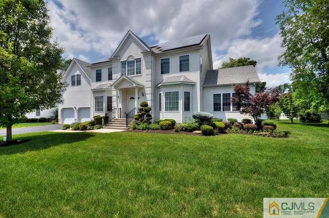 2 Banko Farm Road Dayton, NJ 08810 - Photo 1 of 24 a front view of a house with a garden and trees