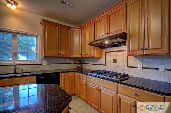 2 Banko Farm Road Dayton, NJ 08810 - Photo 8 of 24 a kitchen with stainless steel appliances granite countertop a stove sink and cabinets