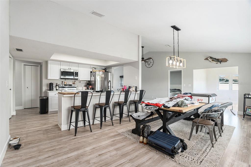 10234 Bedford Road Spring Hill, FL 34608 - Photo 11 of 31 a view of a dining room with furniture and wooden floor