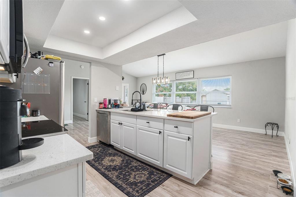 10234 Bedford Road Spring Hill, FL 34608 - Photo 14 of 31 a kitchen with granite countertop a sink stainless steel appliances and cabinets