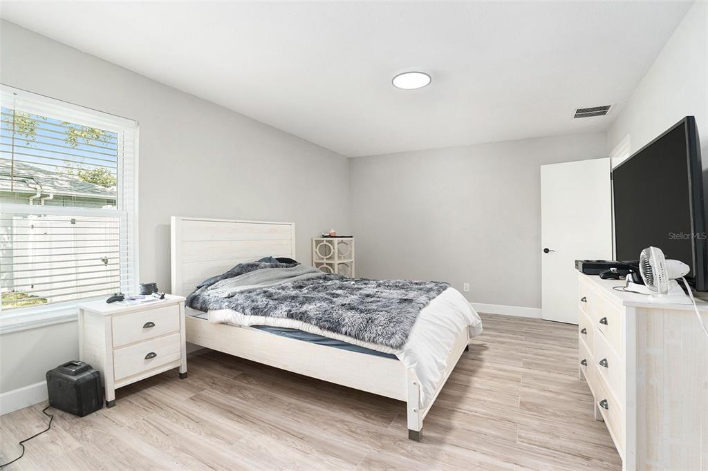 10234 Bedford Road Spring Hill, FL 34608 - Photo 18 of 31 a bedroom with a bed and a tv