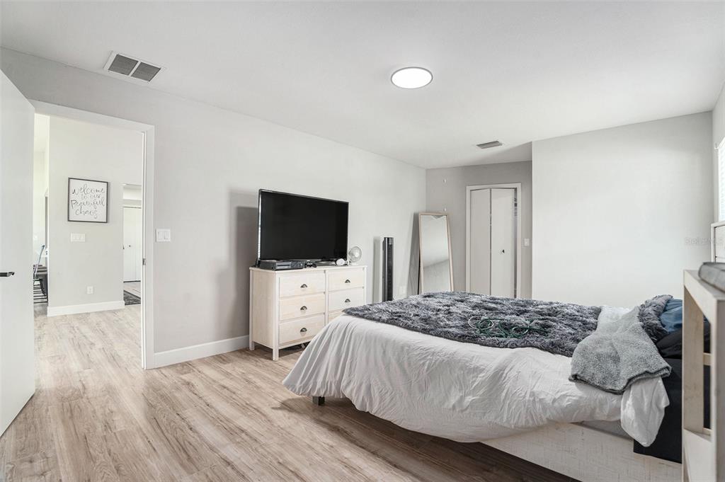 10234 Bedford Road Spring Hill, FL 34608 - Photo 20 of 31 a bedroom with a bed and a flat screen tv