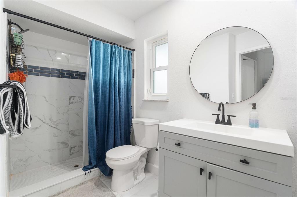 10234 Bedford Road Spring Hill, FL 34608 - Photo 21 of 31 a bathroom with a toilet a sink and mirror
