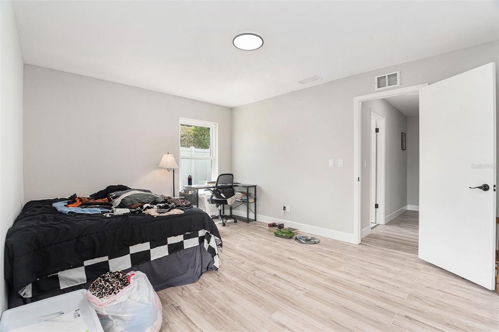 10234 Bedford Road Spring Hill, FL 34608 - Photo 24 of 31 a bedroom with a bed and wooden floor