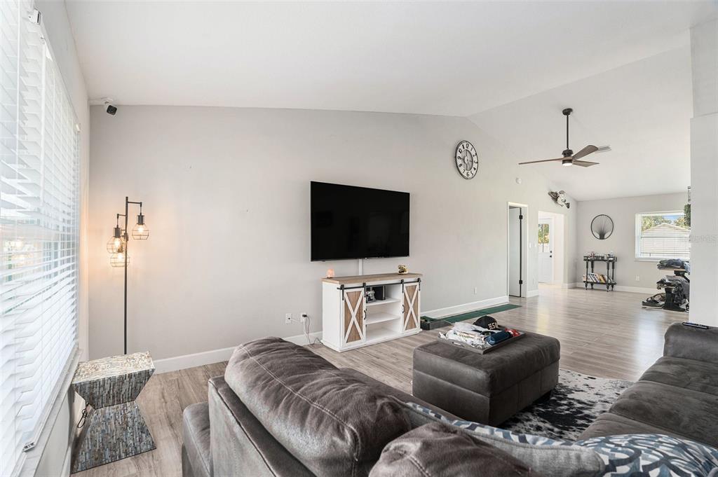 10234 Bedford Road Spring Hill, FL 34608 - Photo 4 of 31 a living room with furniture and a flat screen tv