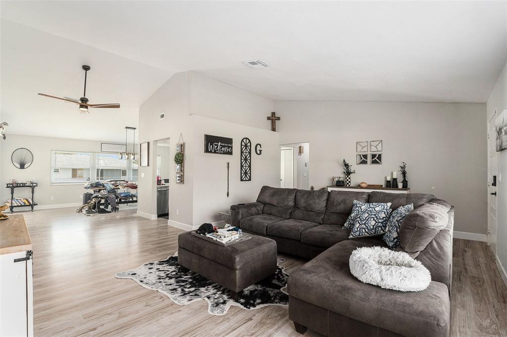 10234 Bedford Road Spring Hill, FL 34608 - Photo 5 of 31 a living room with furniture and wooden floor