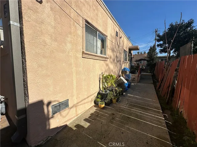 a view of backyard with wheel chair and potted plants