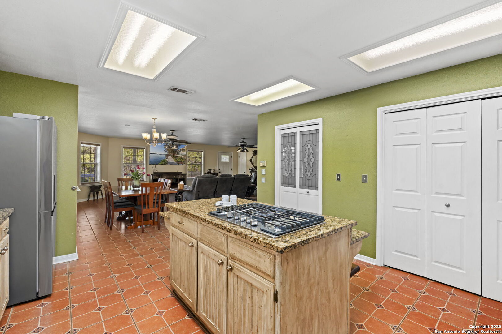 4335 Mail Rte Road Fischer, TX 78623 - Photo 13 of 50 a kitchen with stainless steel appliances granite countertop a refrigerator a sink dishwasher a dining table and chairs with wooden floor