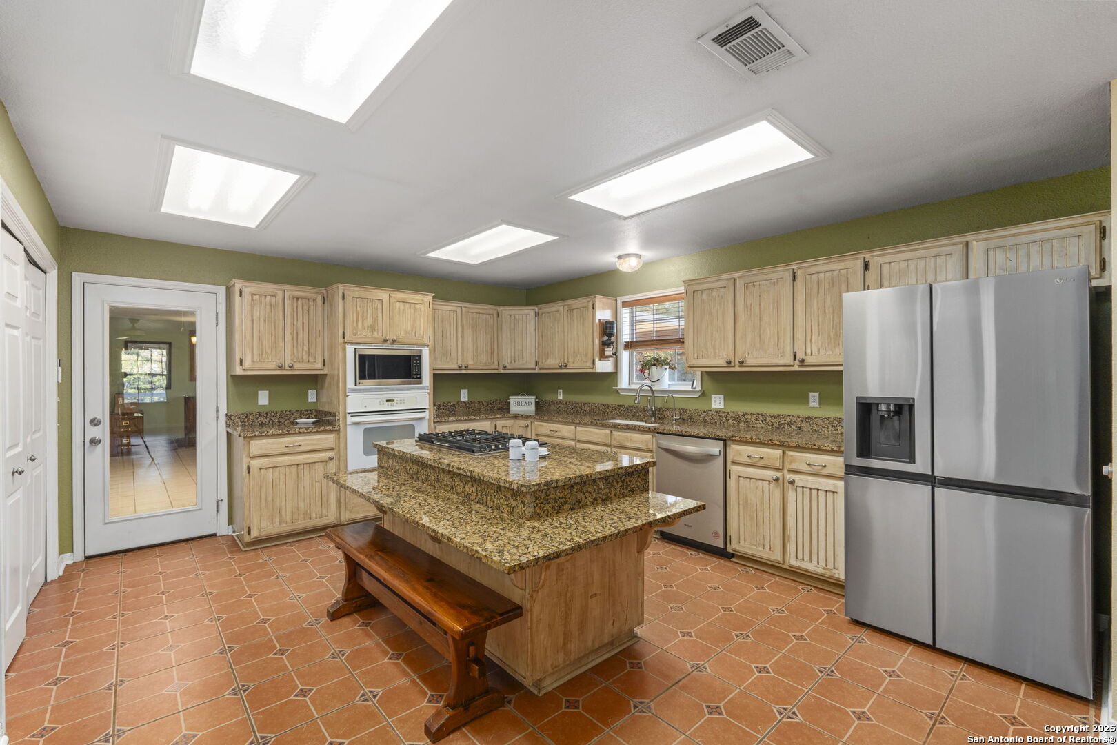4335 Mail Rte Road Fischer, TX 78623 - Photo 17 of 50 a kitchen with refrigerator a stove and cabinets