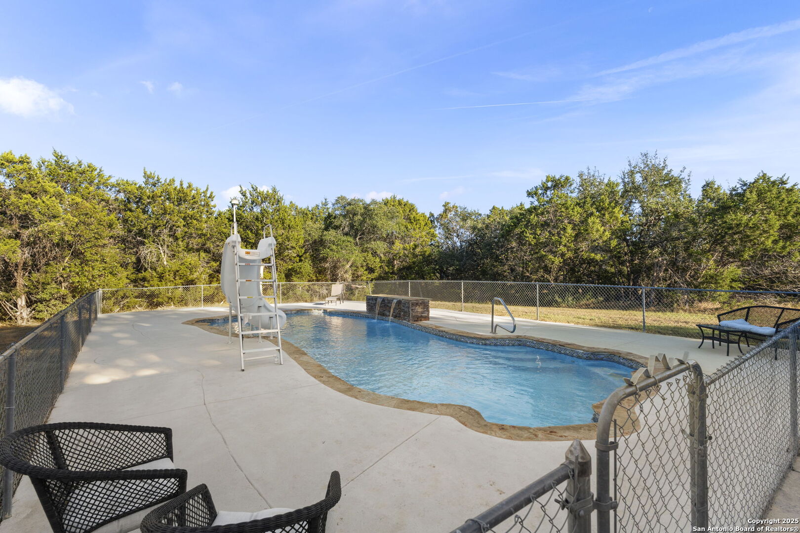 4335 Mail Rte Road Fischer, TX 78623 - Photo 40 of 50 a view of a swimming pool with an outdoor seating and a garden