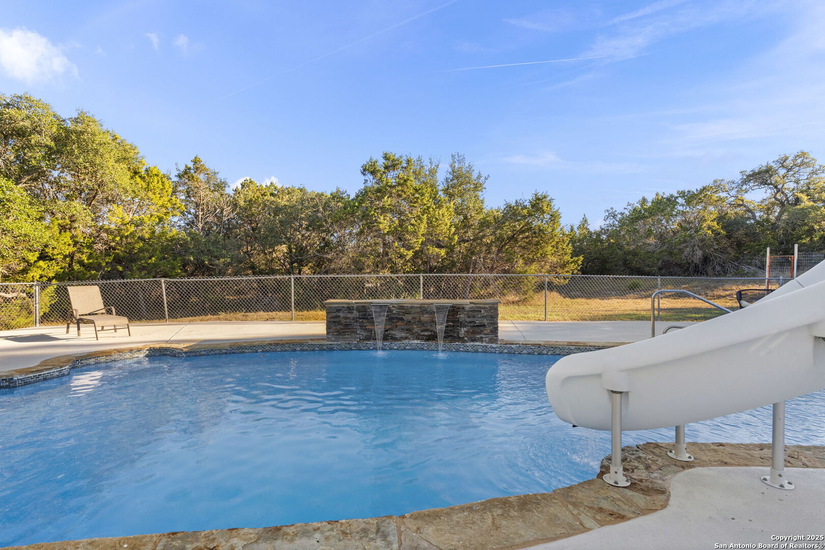 4335 Mail Rte Road Fischer, TX 78623 - Photo 41 of 50 a view of a swimming pool with an outdoor seating and a garden