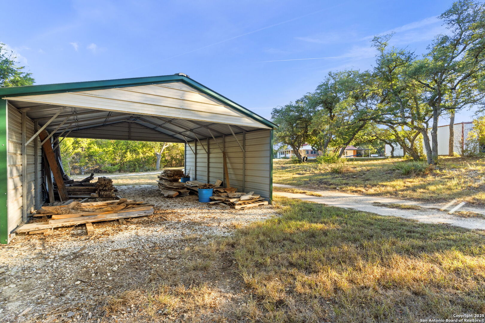 4335 Mail Rte Road Fischer, TX 78623 - Photo 44 of 50 a view of a backyard with table and chairs under an umbrella