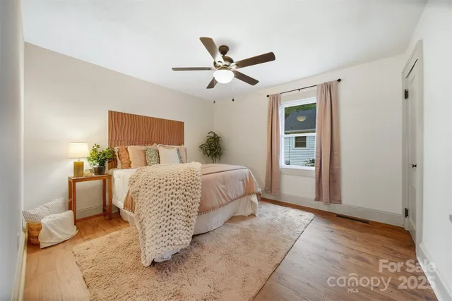 a bedroom with a bed and ceiling fan