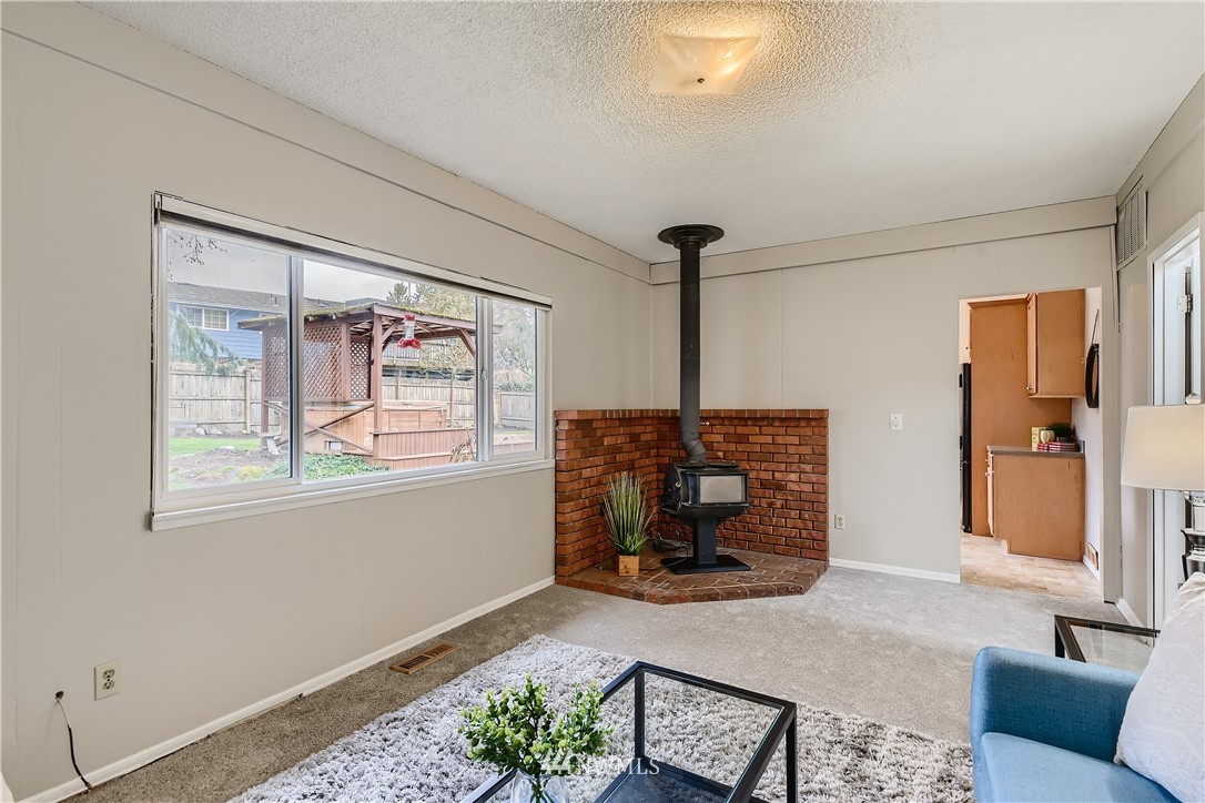 706 221st Street Southwest Bothell, WA 98021 - Photo 15 of 27 a living room with furniture and a fireplace
