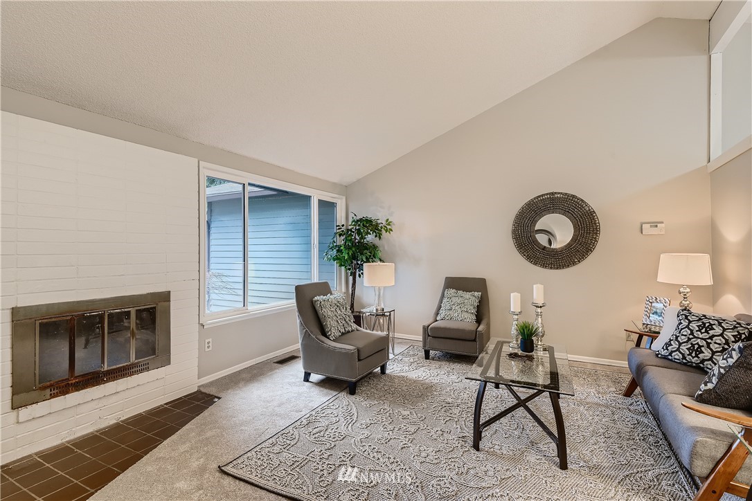 706 221st Street Southwest Bothell, WA 98021 - Photo 4 of 27 a living room with furniture and a fireplace