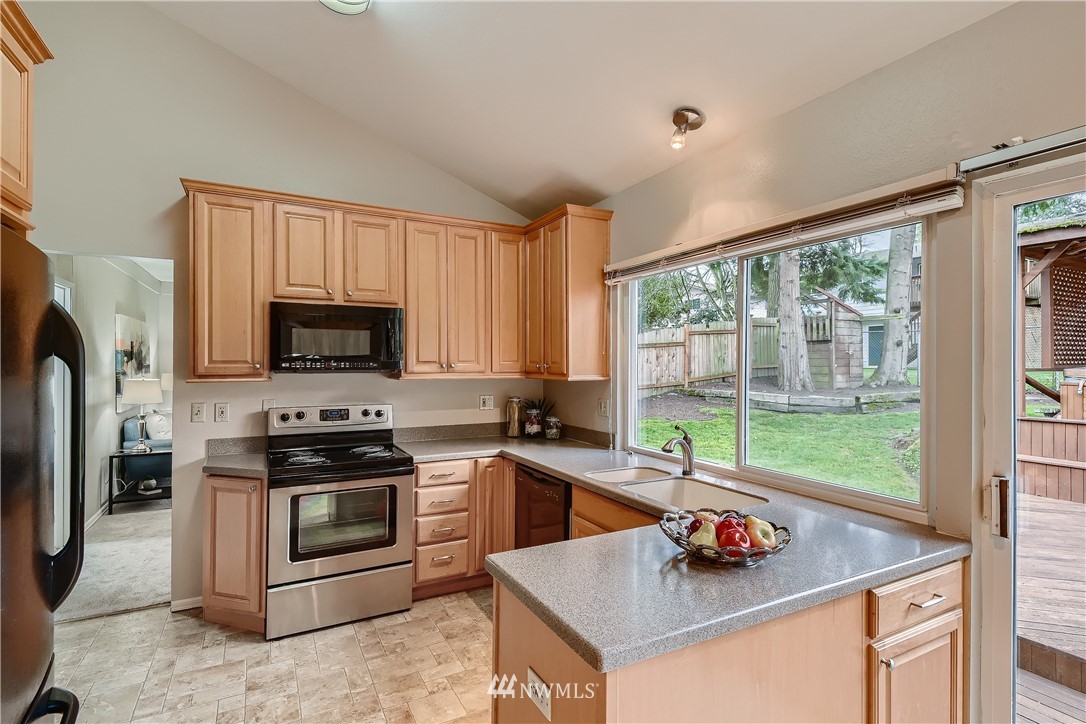 706 221st Street Southwest Bothell, WA 98021 - Photo 8 of 27 a kitchen with stainless steel appliances a stove sink microwave and refrigerator