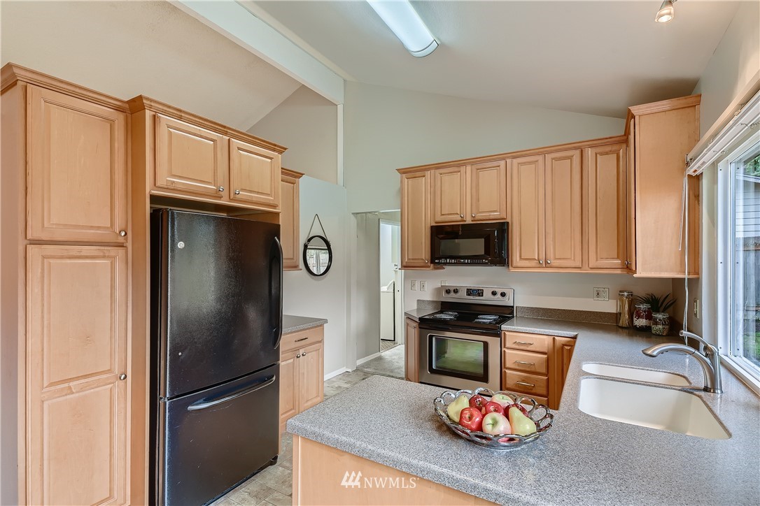 706 221st Street Southwest Bothell, WA 98021 - Photo 9 of 27 a kitchen with stainless steel appliances granite countertop a refrigerator stove top oven a sink and dishwasher