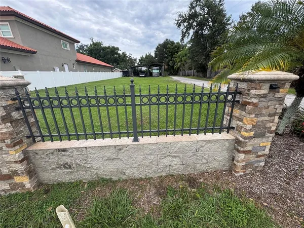 a green field with lots of trees in the background