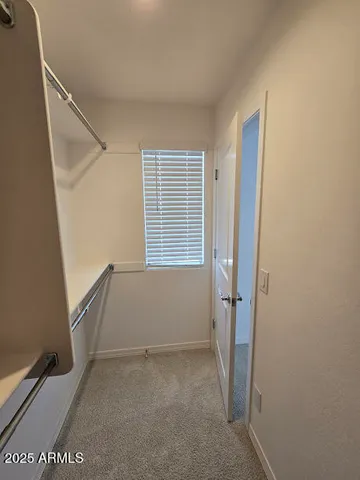 a view of a big room with windows and chandelier