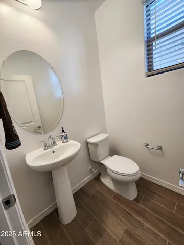 a bathroom with a sink toilet and mirror
