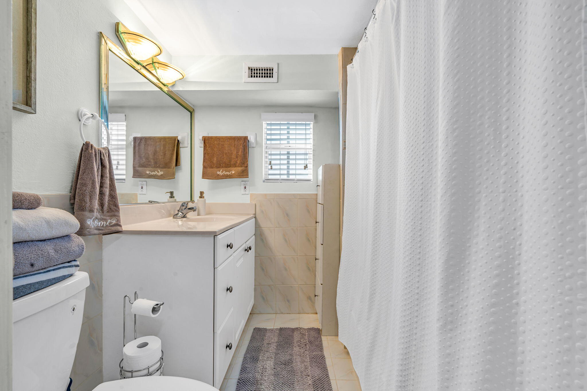 136 Sable Palm Lane Tavernier, FL 33070 - Photo 15 of 39 a bathroom with a sink a toilet and a mirror